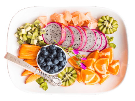 Vibrant tropical fruit platter with dragon fruit and more, shot from above.